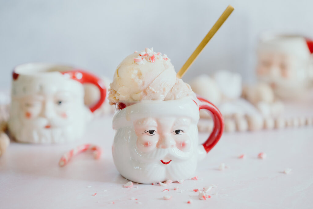 Dairy-free Peppermint Candy Cane Ice Cream in a Santa mug topped with crushed peppermint candy